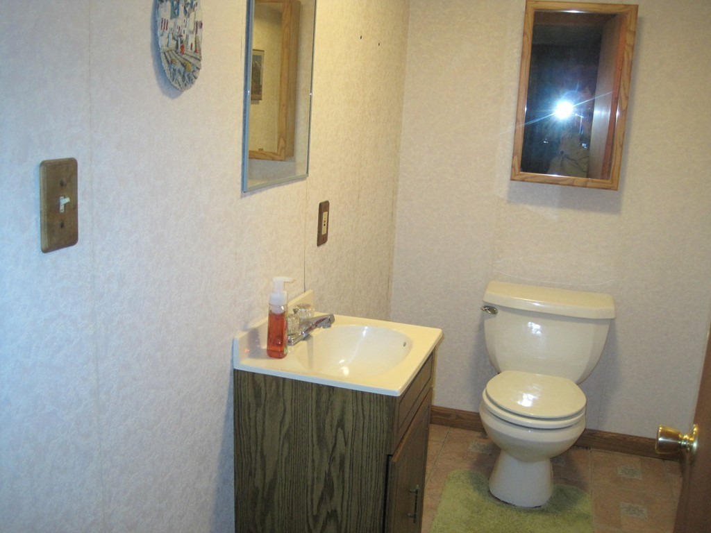15 Kimbrough Road Billerica, MA 01821 - Photo 10 of 15 a bathroom with a toilet a sink and mirror