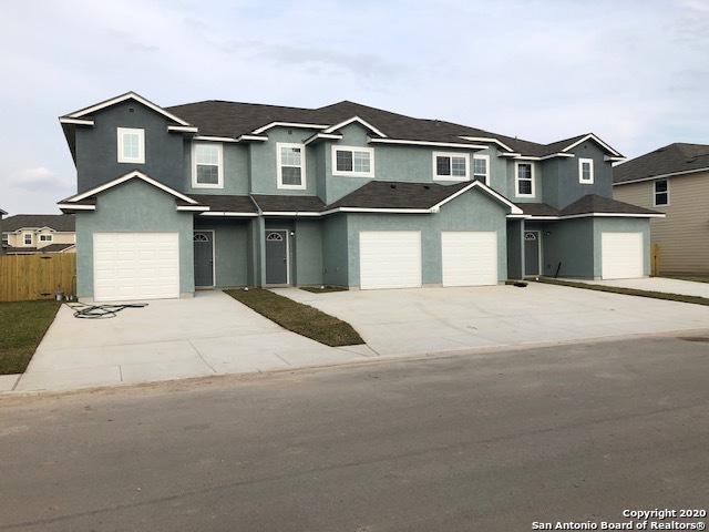16910 Dancing Ava, Unit 4 Selma, TX 78154 - Photo 1 of 1 a front view of a house with a yard and garage