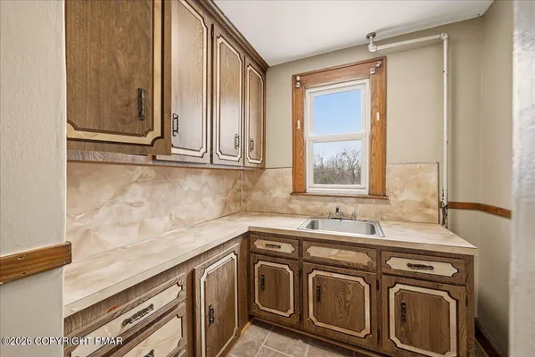 a view of a sink and dishwasher with a washer dryer
