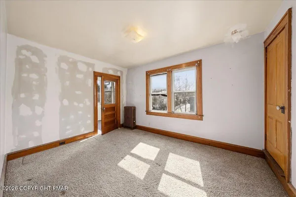 a view of an empty room with a window