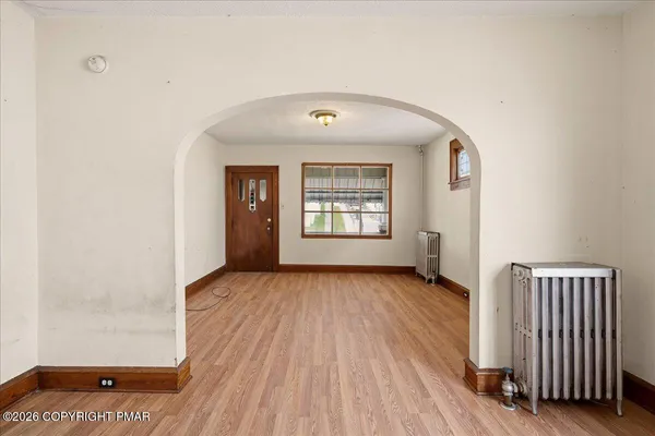 wooden floor in an empty room with a window