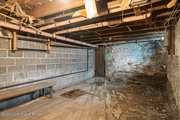 a view of a big house with a big yard and large trees