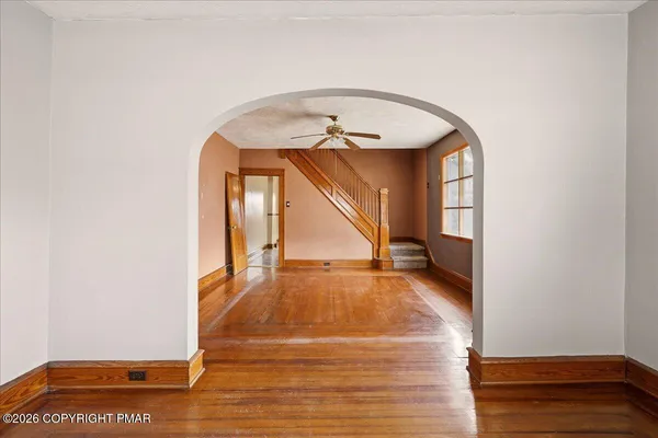 a view of an entryway with wooden floor