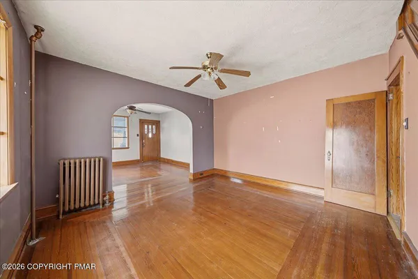wooden floor in an empty room with a window