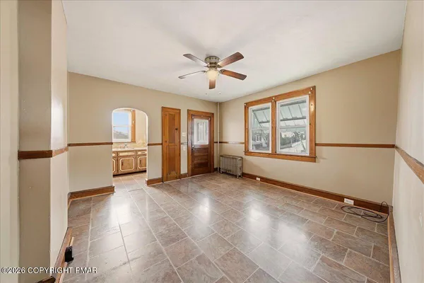 a view of a kitchen with furniture and a ceiling fan