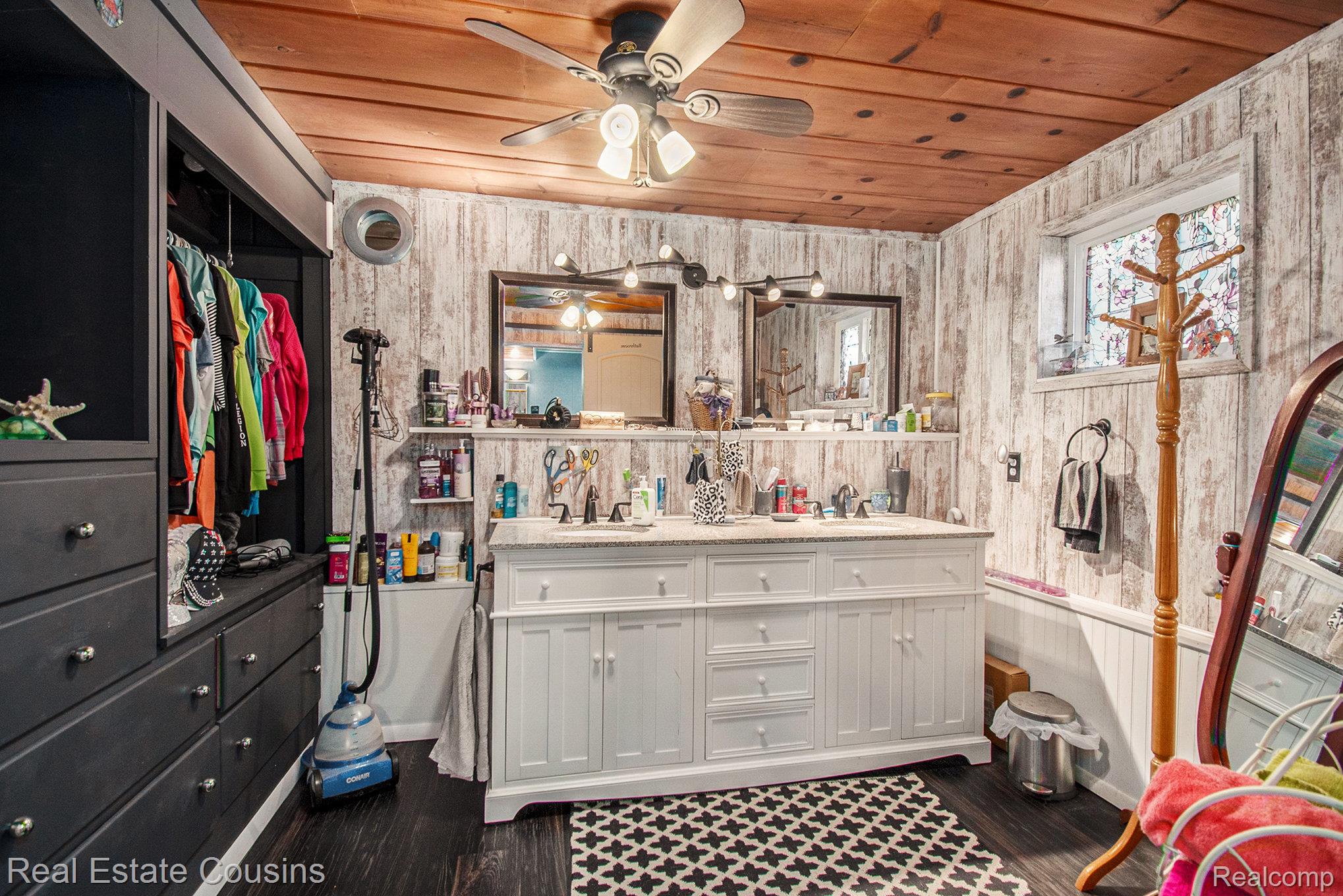 1734 Forest Road Harrison, MI 48625 - Photo 16 of 31 Full bath with wood ceiling, double vanity, dark wood-style flooring, wooden walls, and a ceiling fan