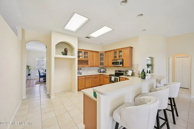 a bathroom with a shower sink and mirror