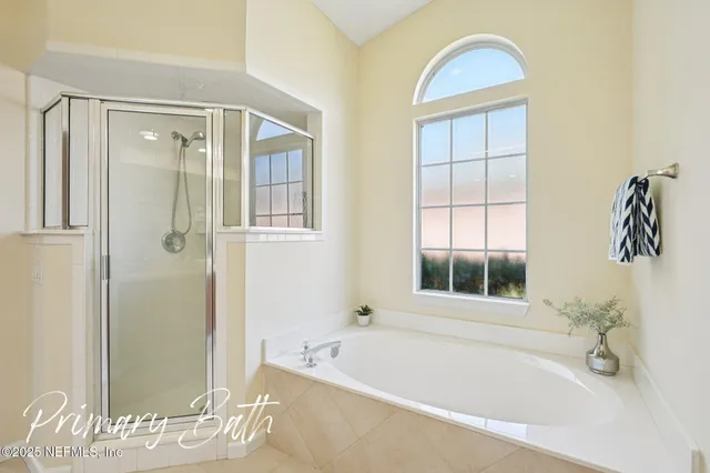 an aerial view of residential house with outdoor space and trees all around