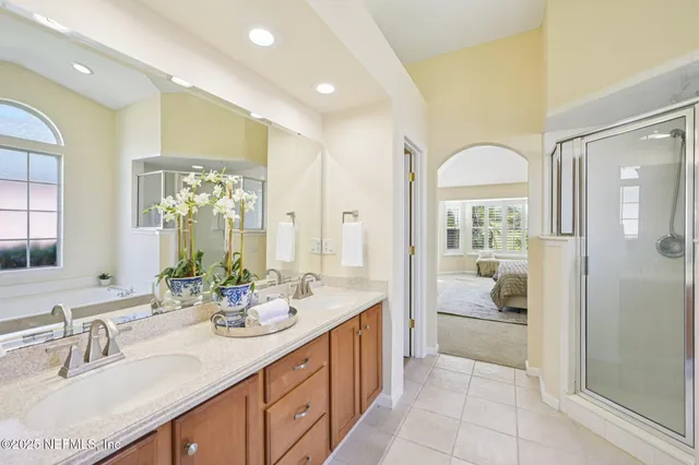 an aerial view of residential house with outdoor space and trees all around