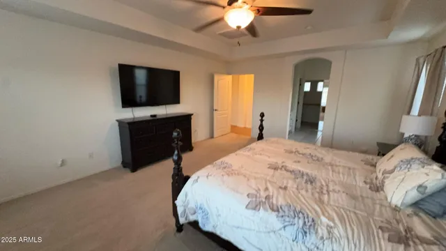 a spacious bedroom with a bed and window