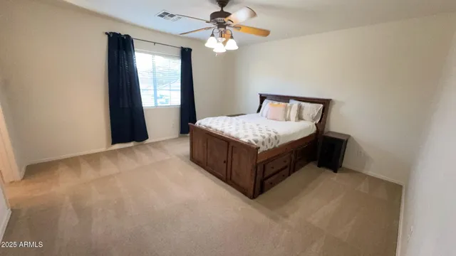 a bedroom with a bed and a night stand