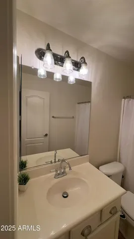 an empty room with a flat screen tv and a window