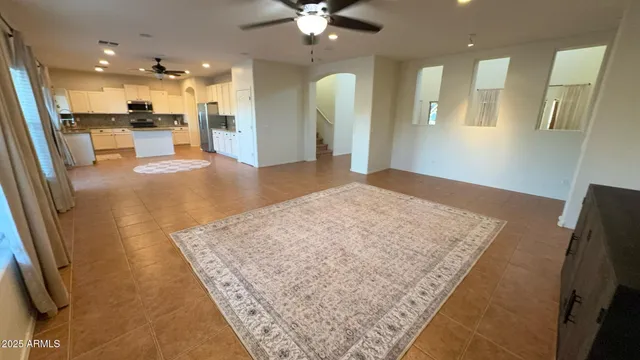 a kitchen with stainless steel appliances a refrigerator a sink a stove a microwave a counter top space and cabinets