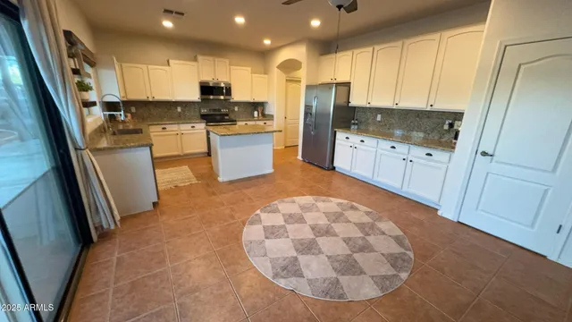 a kitchen with a sink stove and refrigerator