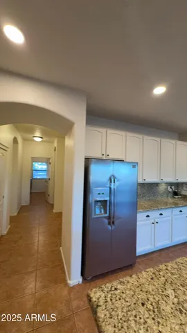 a bed room with a bed and a flat tv screen on dresser