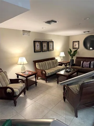 a living room with furniture a lamp and a window