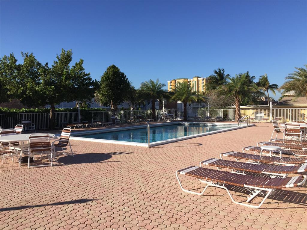 1009 North Ocean Boulevard, Unit 212 Pompano Beach, FL 33062 - Photo 18 of 23 a view of patio with swimming pool and seating