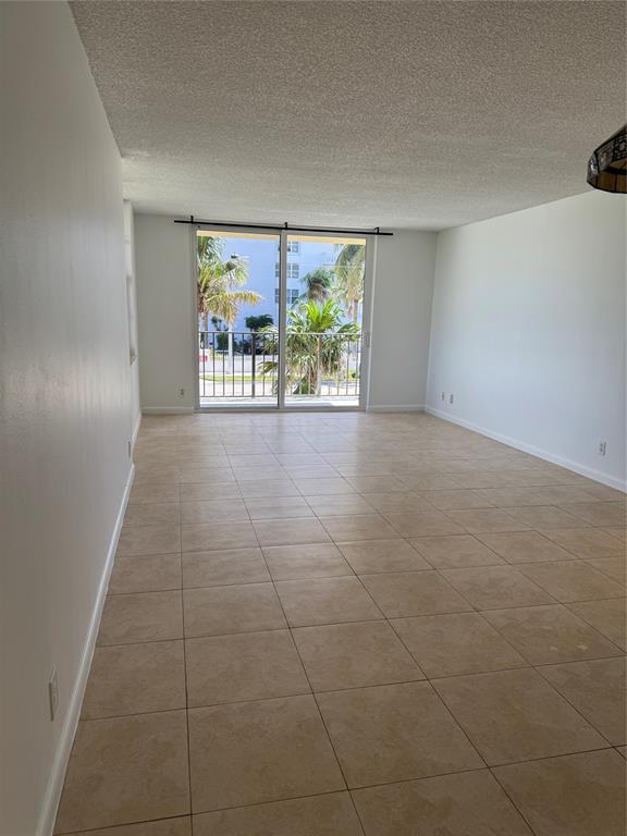 1009 North Ocean Boulevard, Unit 212 Pompano Beach, FL 33062 - Photo 3 of 23 a view of an empty room with a window