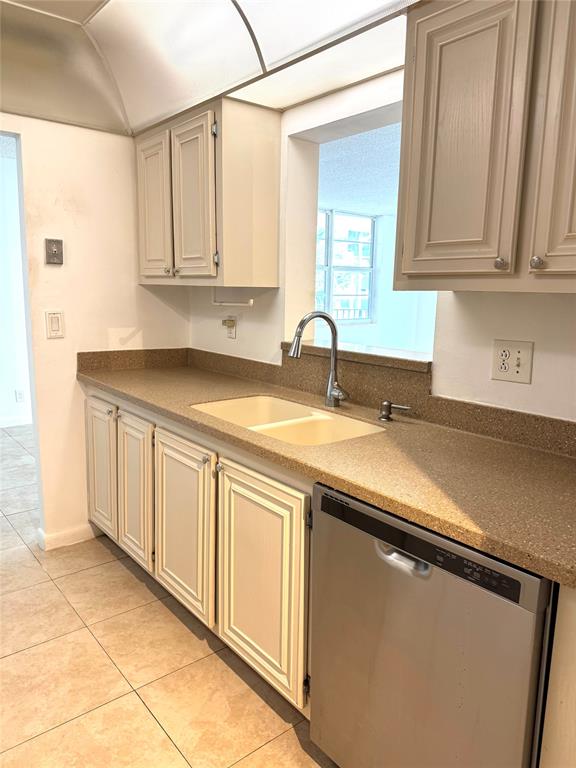1009 North Ocean Boulevard, Unit 212 Pompano Beach, FL 33062 - Photo 7 of 23 a kitchen with stainless steel appliances granite countertop a sink and dishwasher with white cabinets