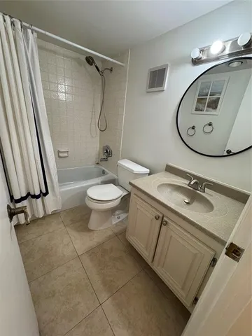 a bathroom with a sink toilet and a mirror