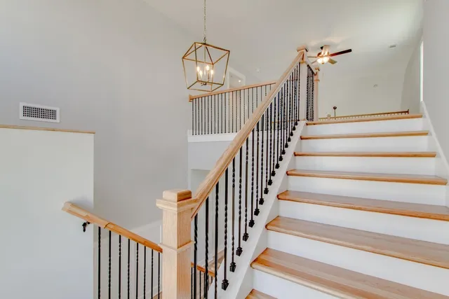 a view of a livingroom with a ceiling fan and windows