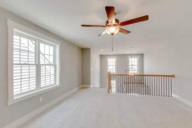 a spacious bathroom with a granite countertop sink a toilet and a mirror