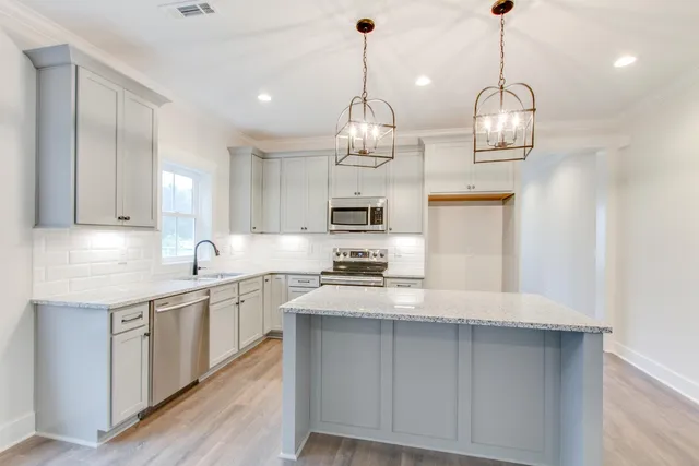 a bathroom with a granite countertop sink a mirror a shower and a bathtub