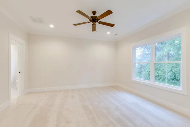 an empty room with windows and closet