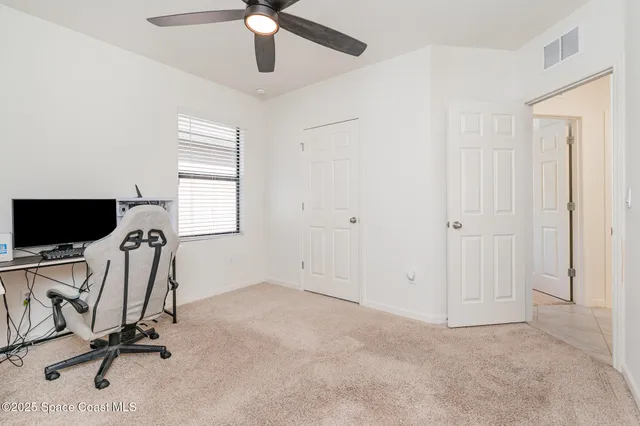 a view of a livingroom with a ceiling fan and a window