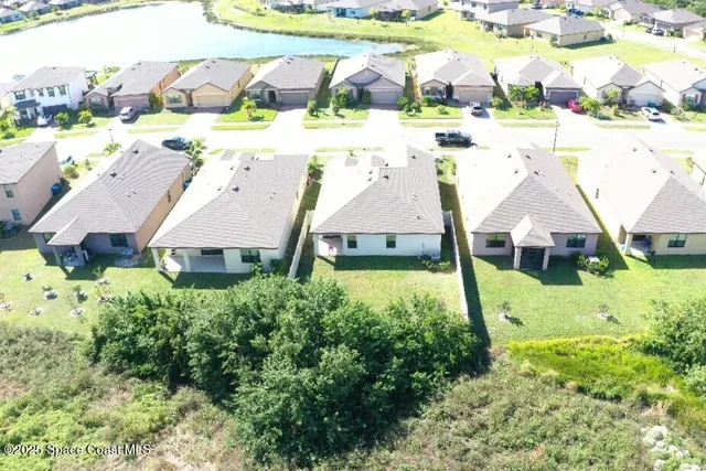 an aerial view of a house with a yard basket ball court and outdoor seating