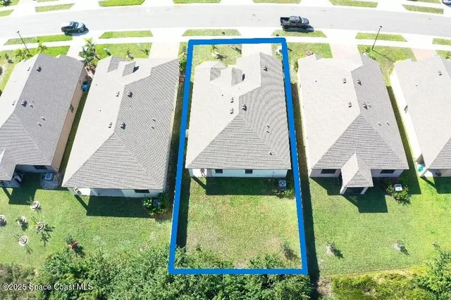 an aerial view of a house with swimming pool garden and patio