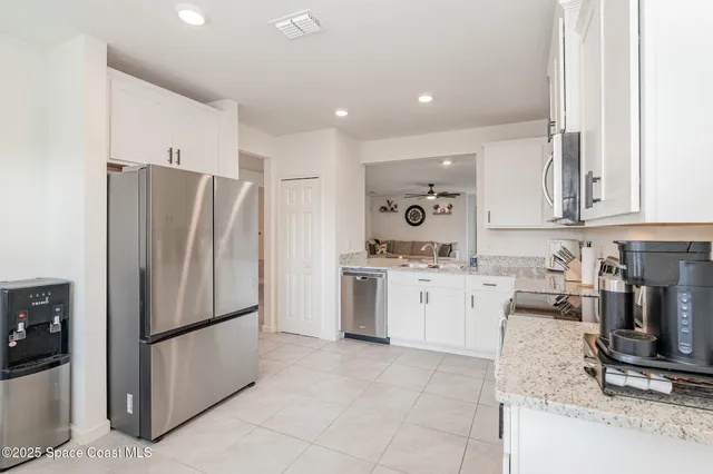 a kitchen with a refrigerator and a stove top oven
