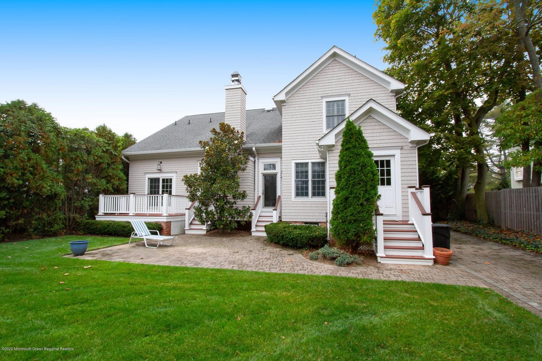 63 River Road Rumson, NJ 07760 - Photo 1 of 37 a front view of a house with a yard and tree s