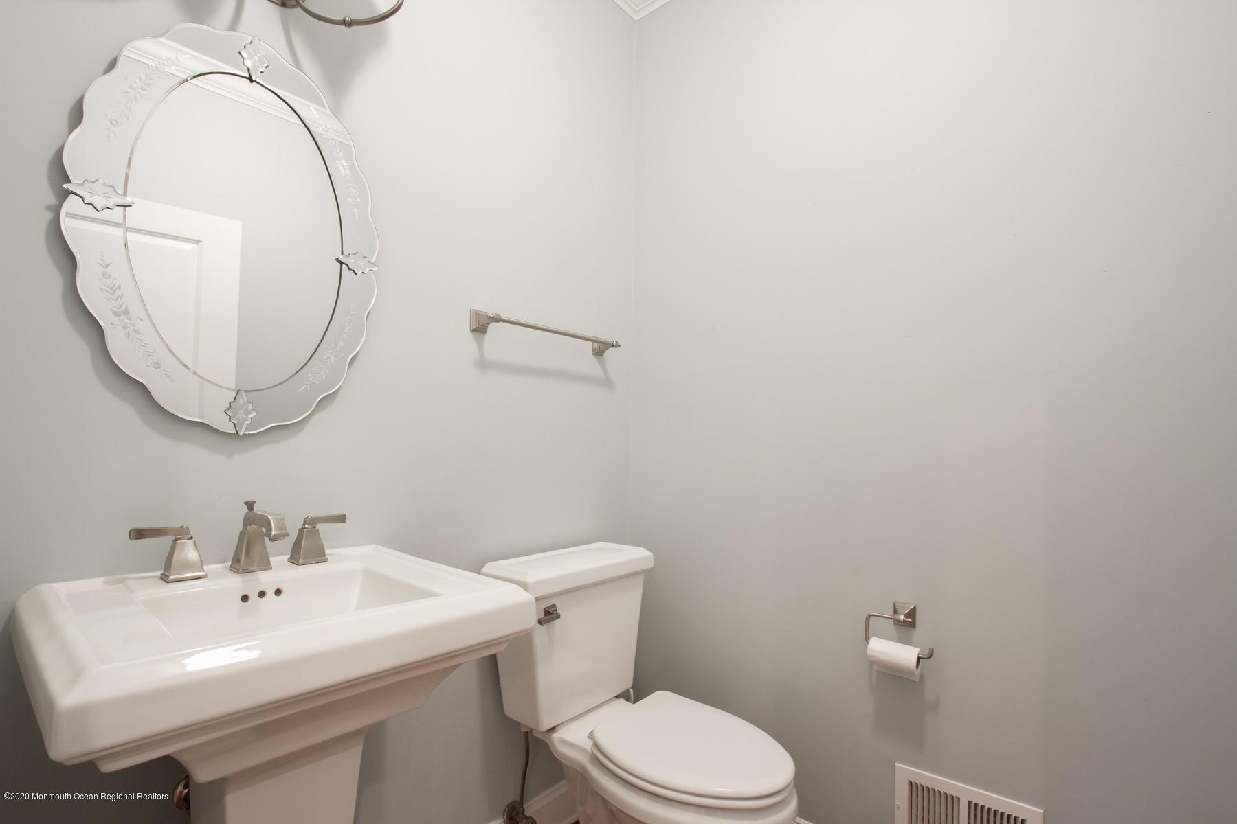 63 River Road Rumson, NJ 07760 - Photo 13 of 37 a bathroom with a sink a toilet and a mirror