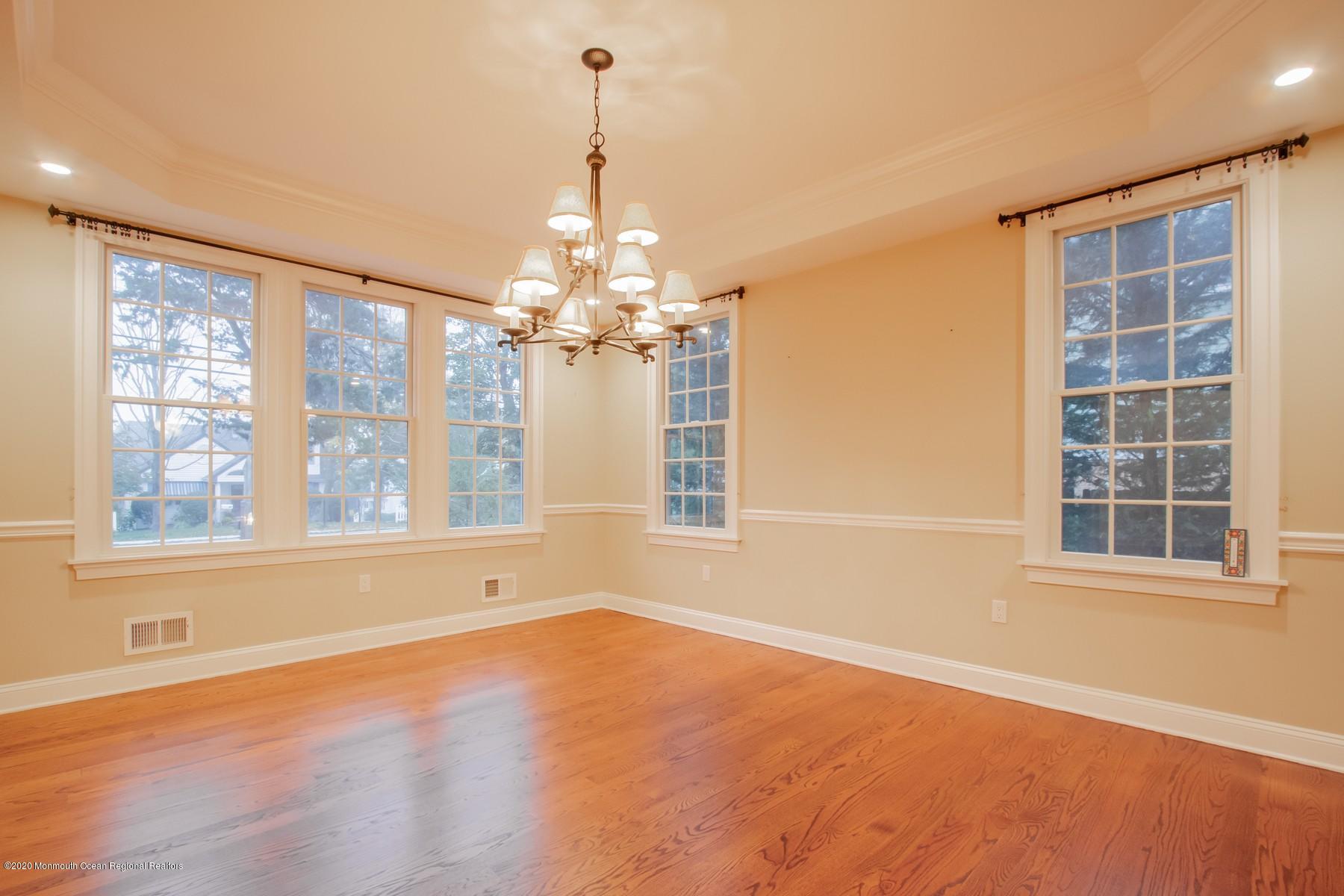 63 River Road Rumson, NJ 07760 - Photo 16 of 37 a view of an empty room with a window and wooden floor