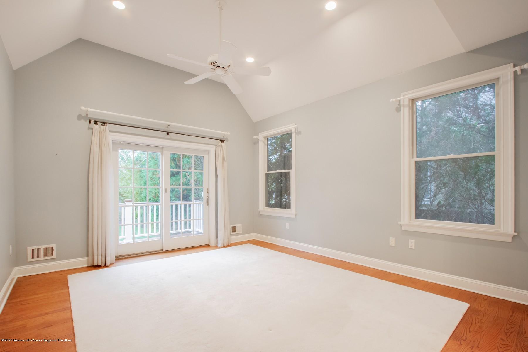 63 River Road Rumson, NJ 07760 - Photo 18 of 37 a bedroom with a large bed and a large window