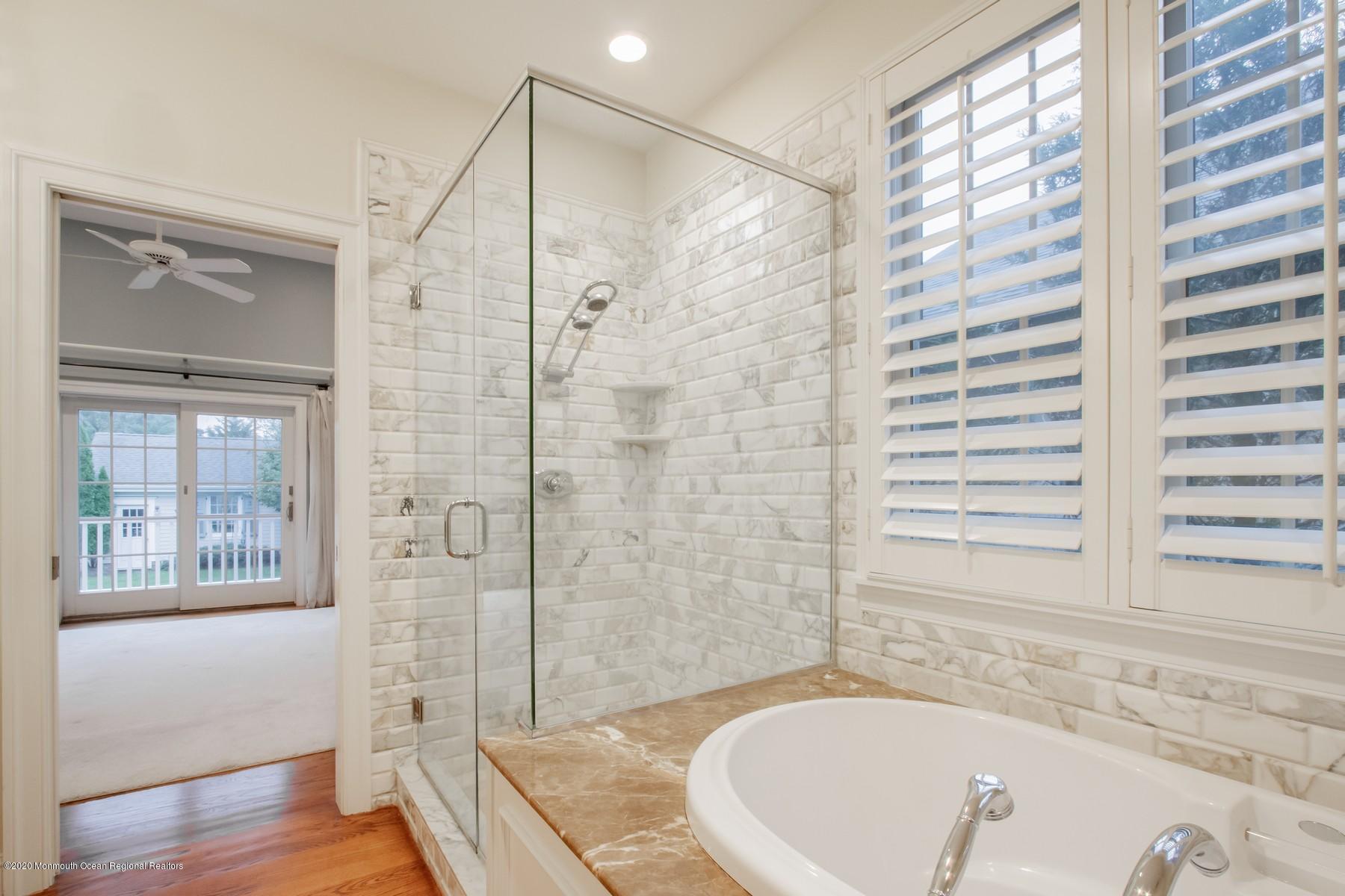 63 River Road Rumson, NJ 07760 - Photo 20 of 37 a bathroom with a bathtub and a shower