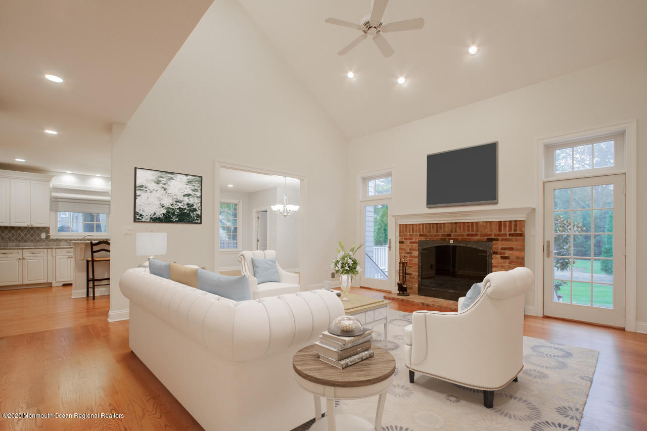 63 River Road Rumson, NJ 07760 - Photo 3 of 37 a living room with furniture a fireplace and a flat screen tv