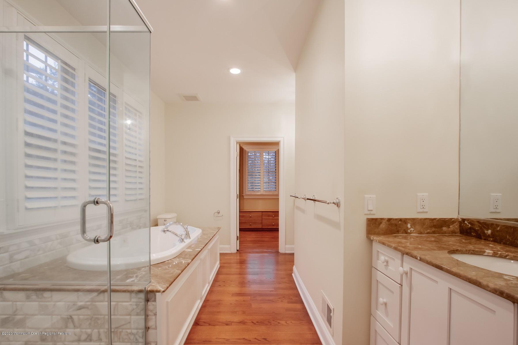 63 River Road Rumson, NJ 07760 - Photo 21 of 37 a bathroom with a sink and mirror