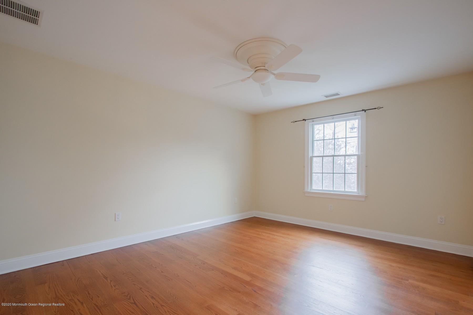 63 River Road Rumson, NJ 07760 - Photo 26 of 37 an empty room with wooden floor and windows