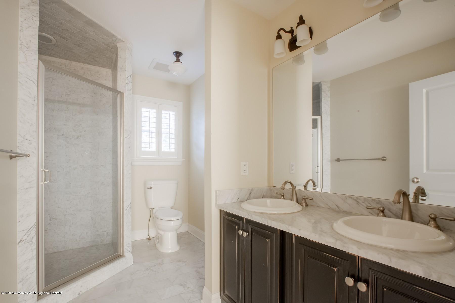 63 River Road Rumson, NJ 07760 - Photo 27 of 37 a bathroom with a double vanity sink toilet and shower