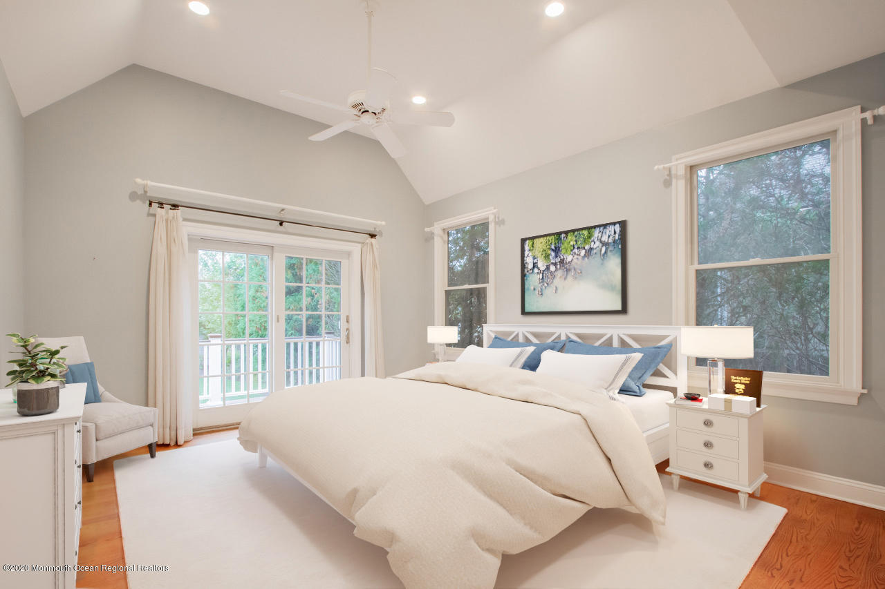 63 River Road Rumson, NJ 07760 - Photo 6 of 37 a bedroom with a large bed and a large window