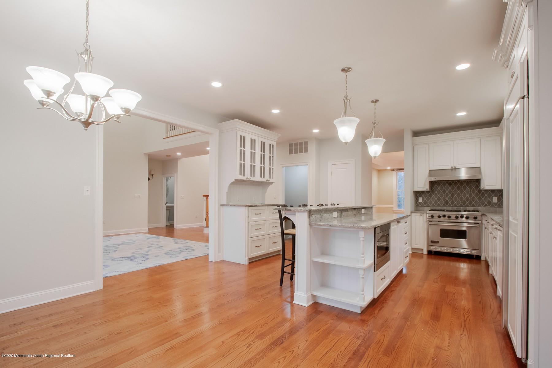 63 River Road Rumson, NJ 07760 - Photo 7 of 37 a kitchen with stainless steel appliances a stove top oven a refrigerator cabinets and wooden floor