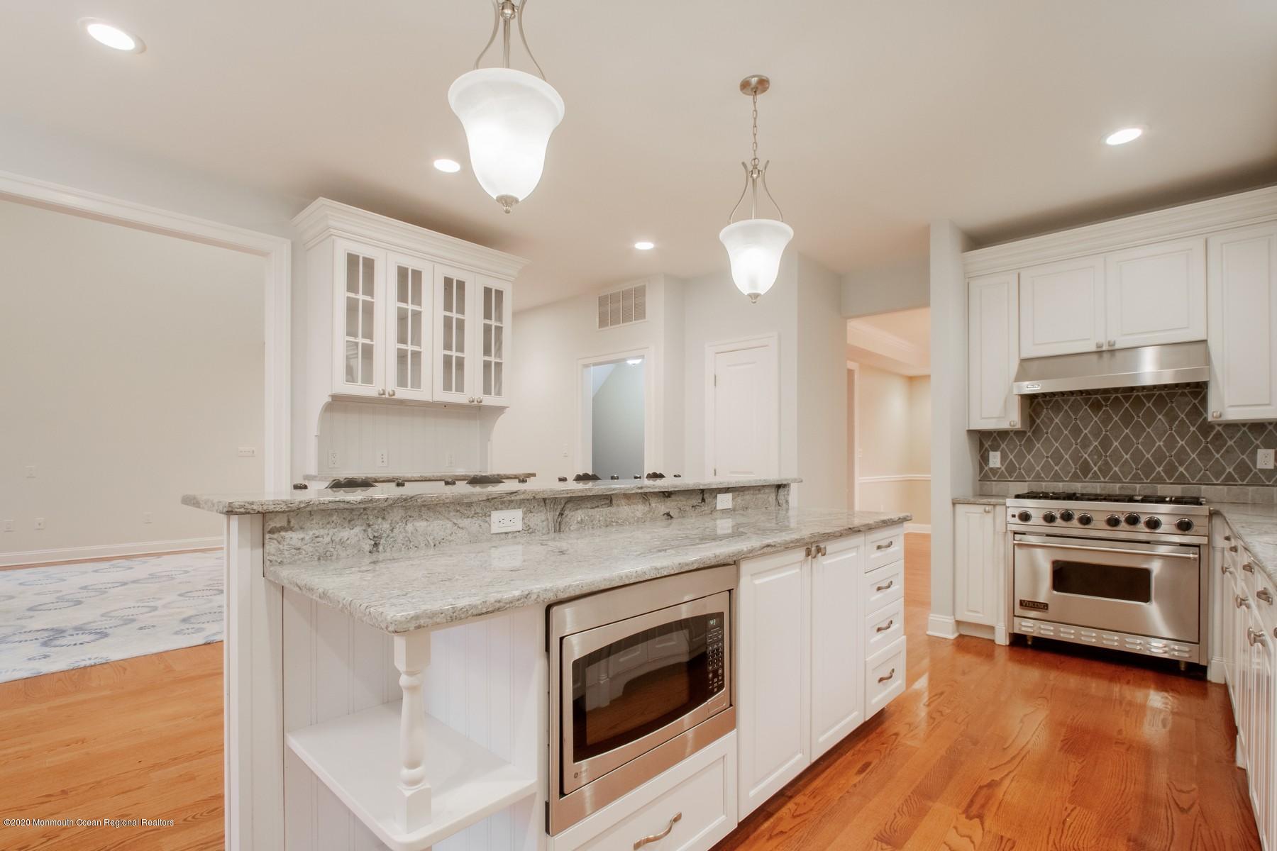 63 River Road Rumson, NJ 07760 - Photo 9 of 37 a kitchen with stainless steel appliances granite countertop a stove and a sink