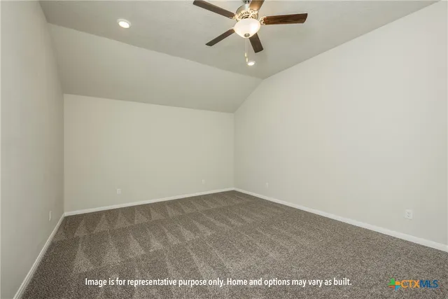an empty room with a ceiling fan and a window