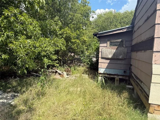 a backyard of a house with table and chairs