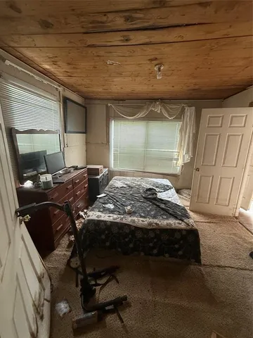 a bedroom with a bed and a mirror