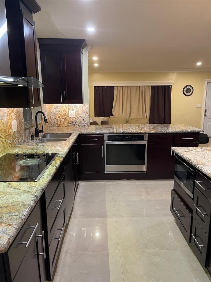 11810 Southwest 176th Street Miami, FL 33177 - Photo 1 of 15 a kitchen with stainless steel appliances granite countertop a sink and a stove