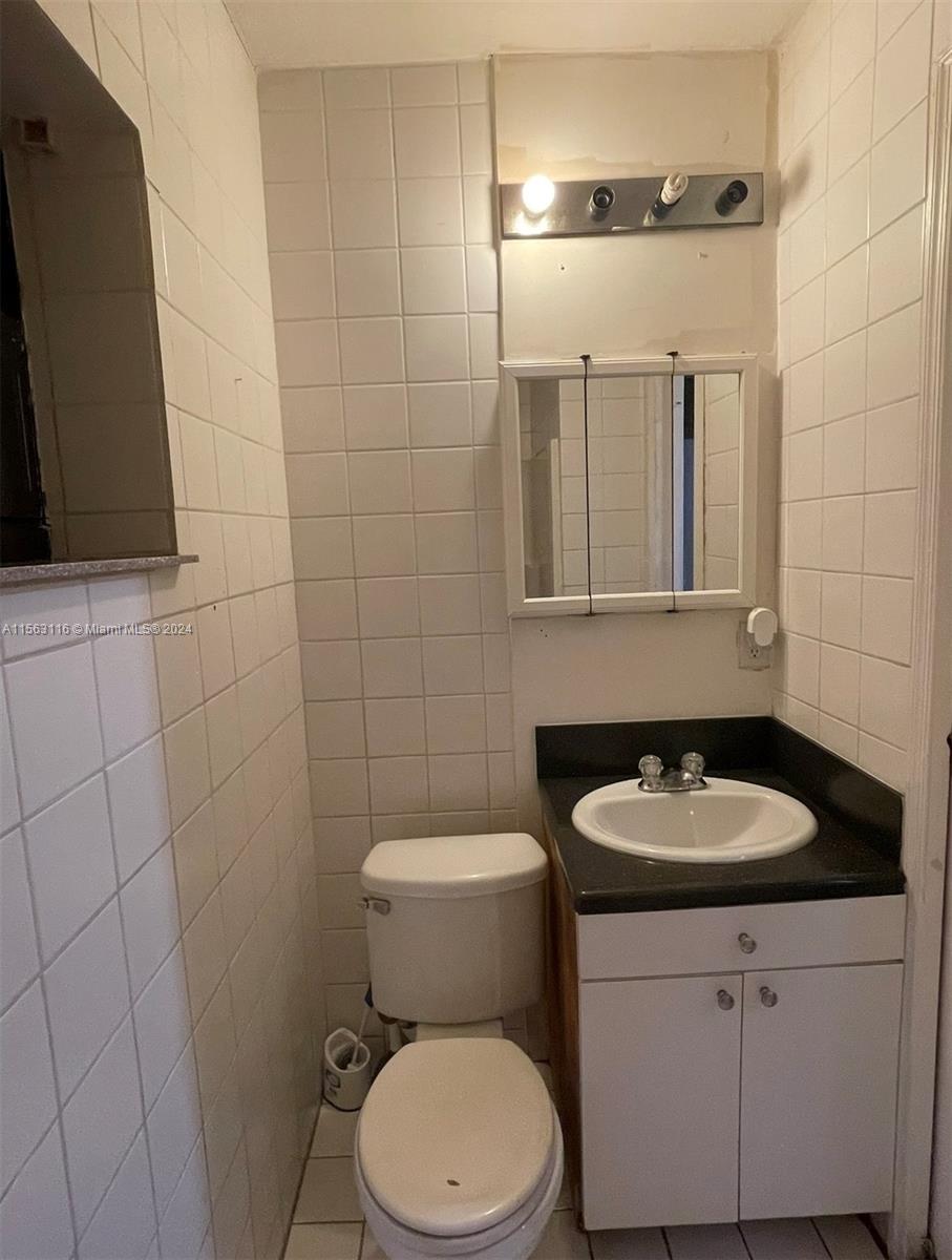 11810 Southwest 176th Street Miami, FL 33177 - Photo 14 of 15 a bathroom with a sink a toilet and a mirror
