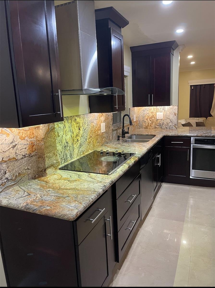11810 Southwest 176th Street Miami, FL 33177 - Photo 4 of 15 a kitchen with stainless steel appliances granite countertop a sink counter space cabinets and a large window